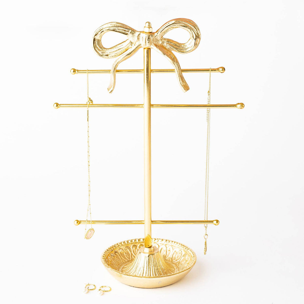 Gold-tone bow jewelry holder with hanging bars and round base tray
