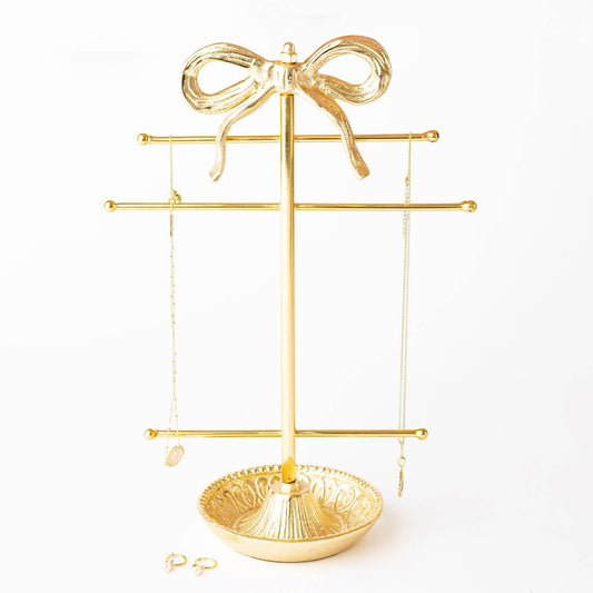 Gold-tone bow jewelry holder with hanging bars and round base tray