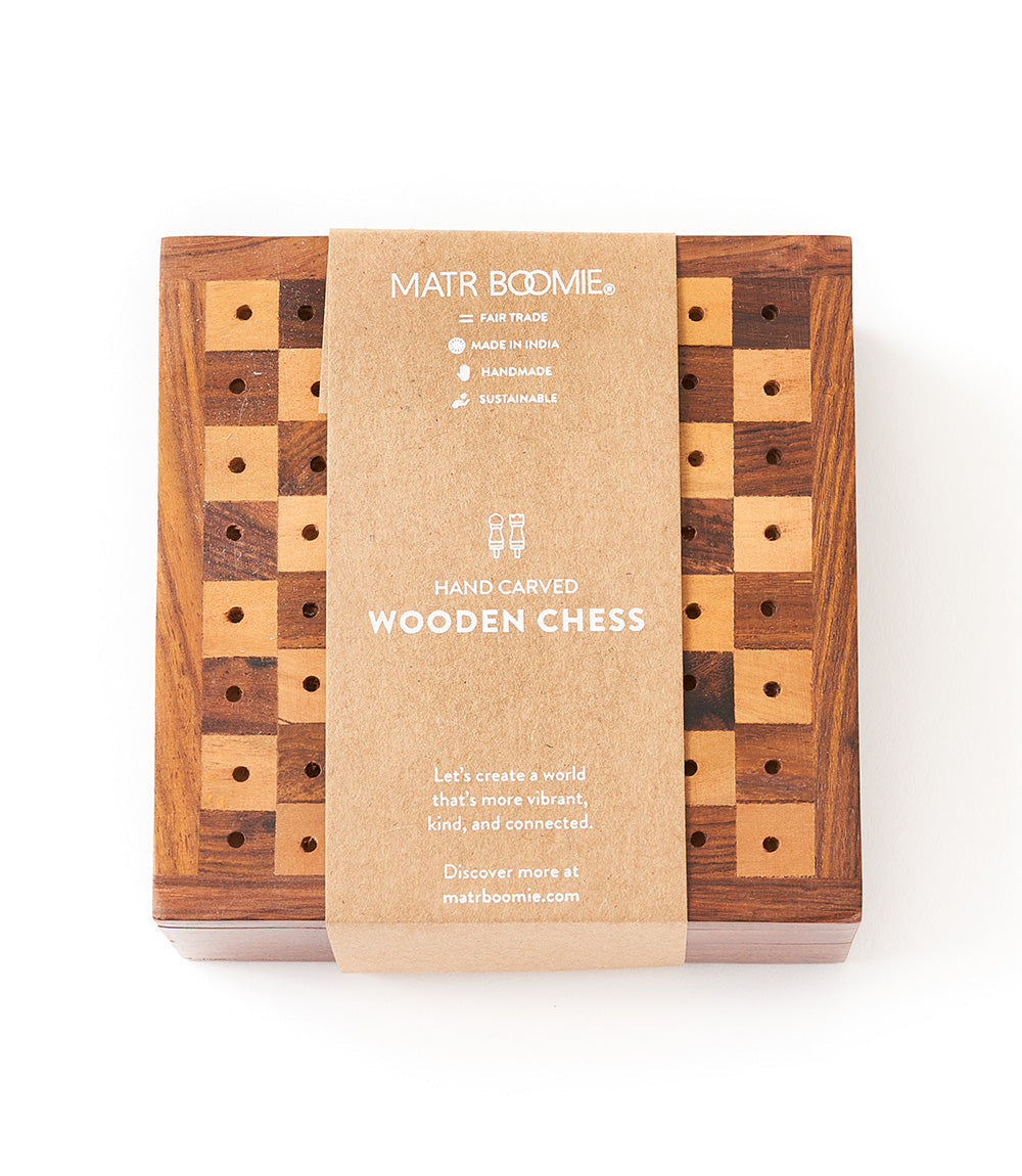 Foldable wooden chess set box displaying board and peg pieces inside