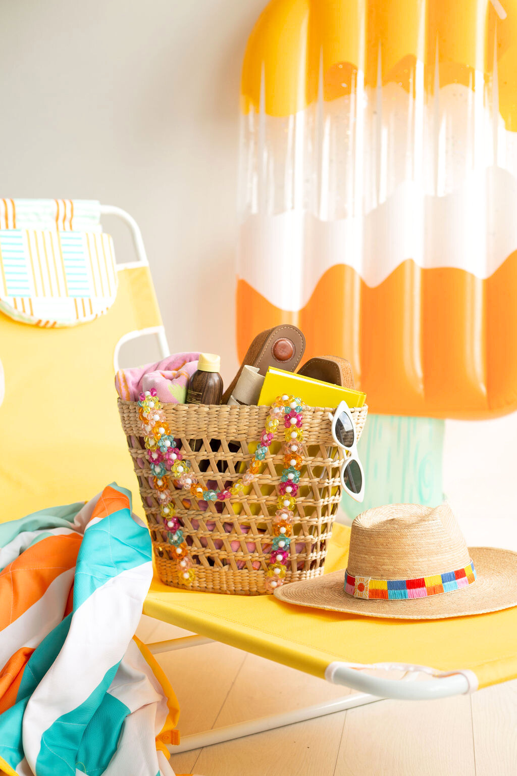 Woven straw tote basket with multicolor beads around handles and sides