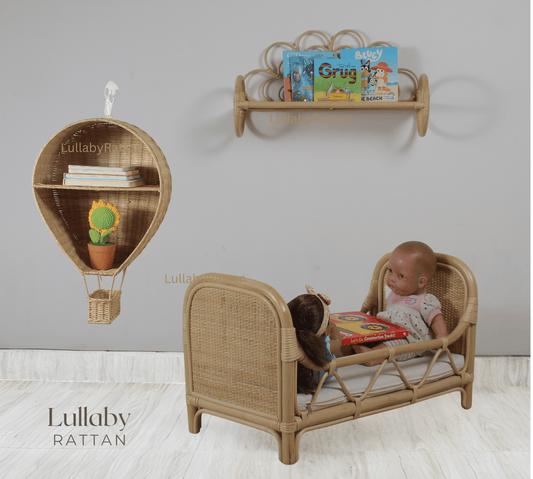Natural rattan wall shelf mounted above a doll bed, holding children's books.