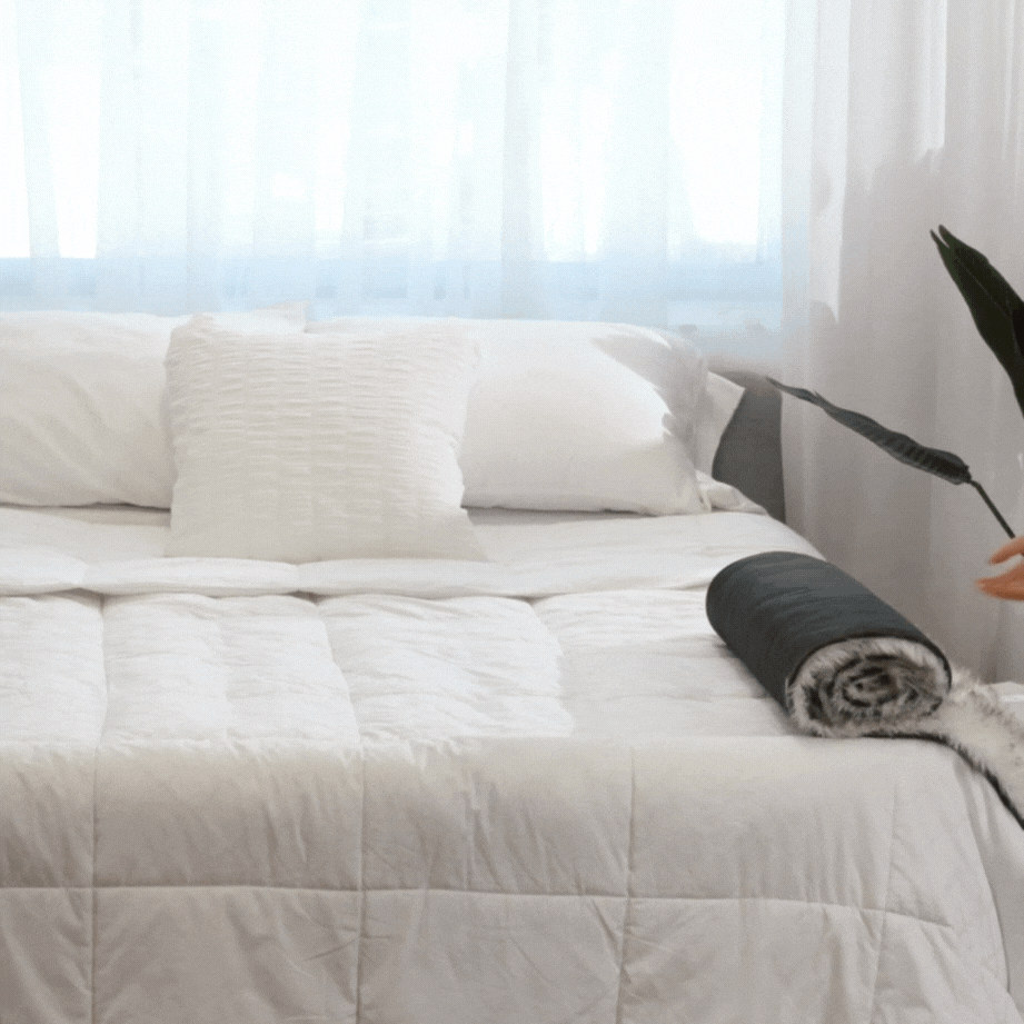 Folded white plush waterproof dog bed runner on a bed surface