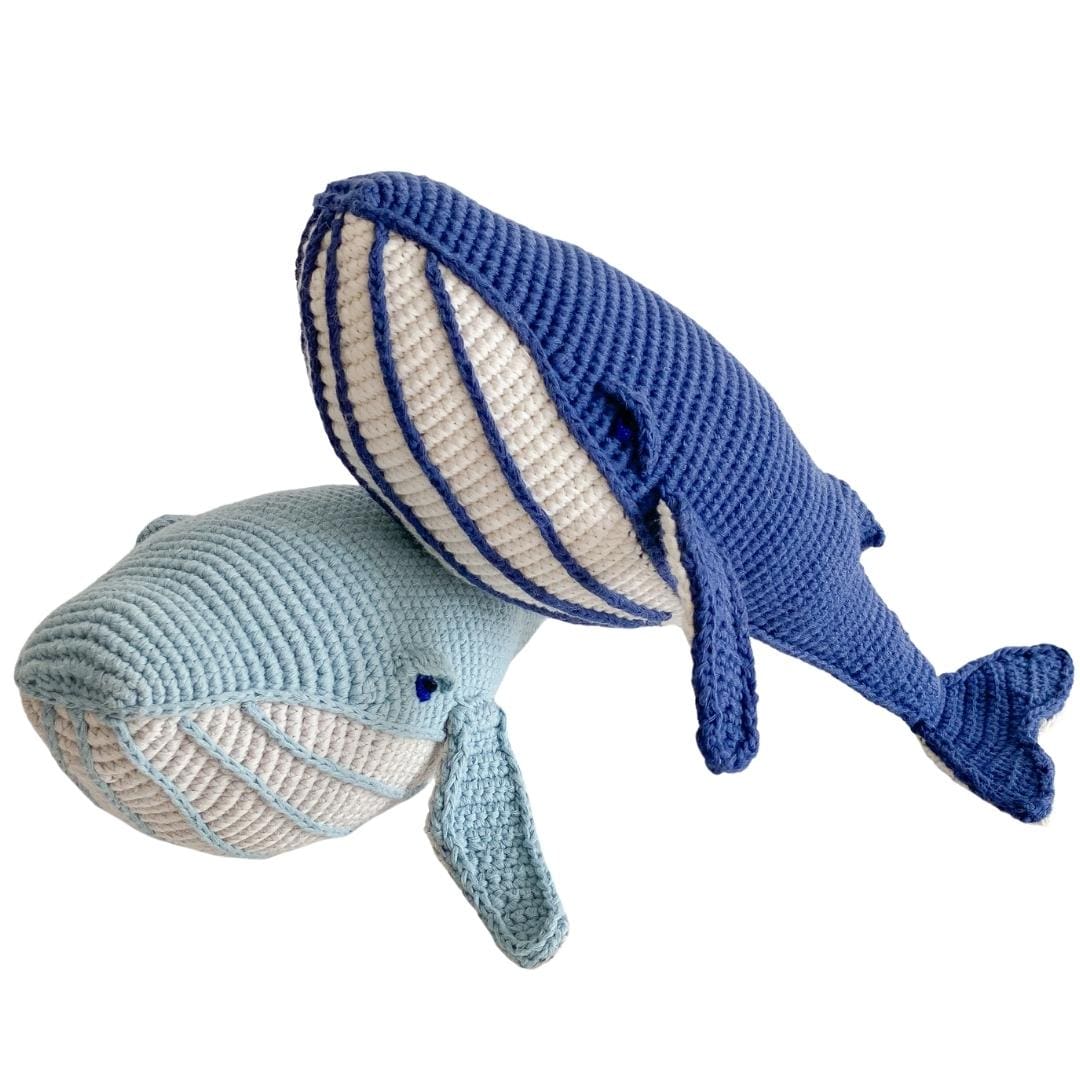 Crocheted whale plush pair in deep blue and pale aqua, with cream striped bellies.