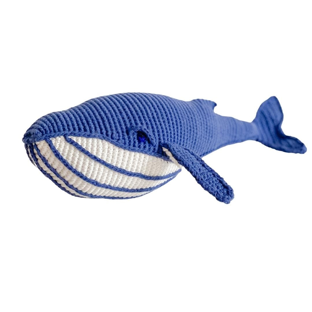 Deep blue crocheted whale plush shown from the front, with cream belly stripes.