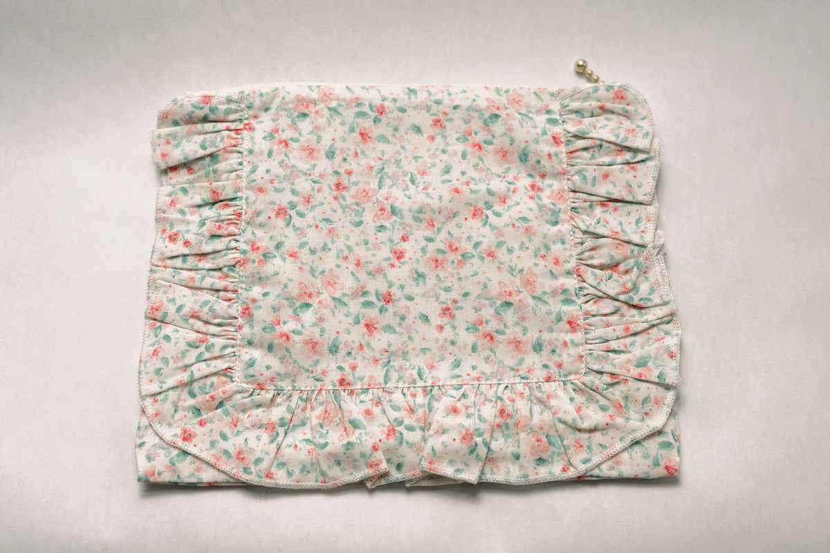 Pastel floral ruffle zip pouch front view with pleated side ruching