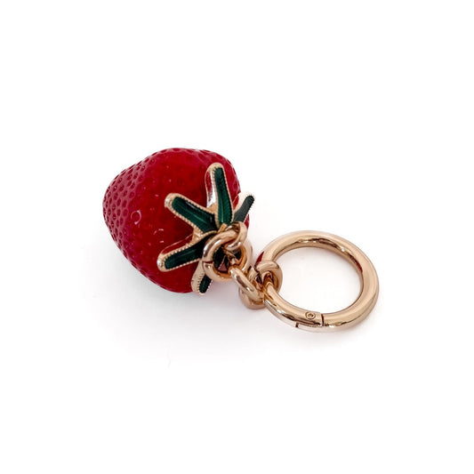 Red strawberry bag charm with green leaf and gold keyring