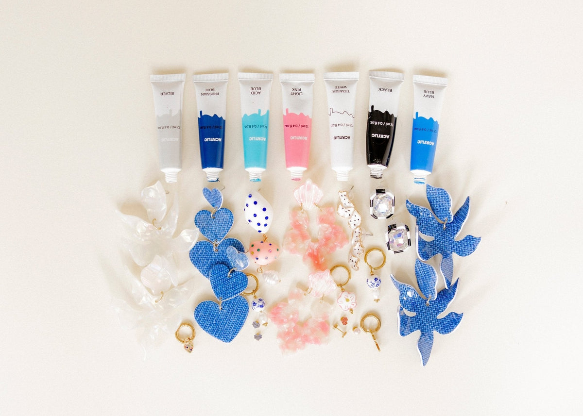 Hanging earring display with blue and pink heart charms and crystal accents