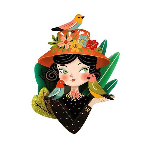Bird lover brooch with illustrated woman, floral hat, colorful birds, green glitter