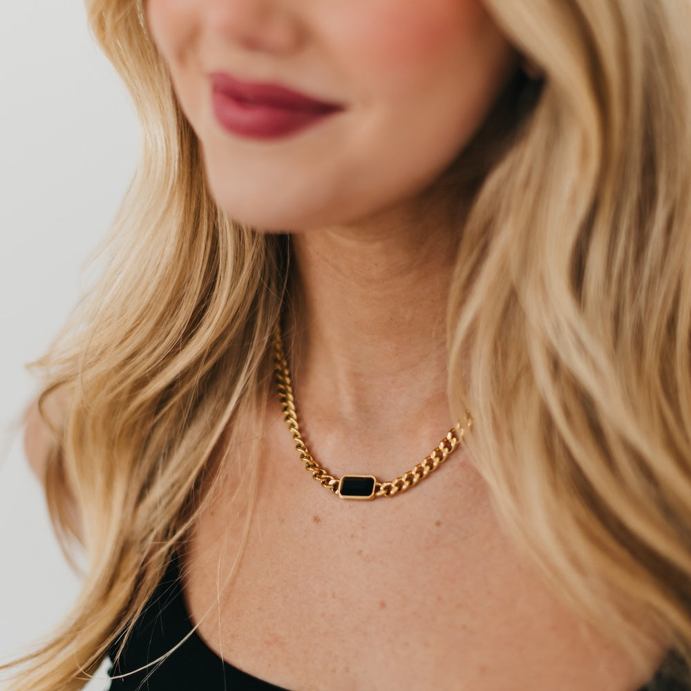 Gold chain necklace with black rectangular bezel pendant