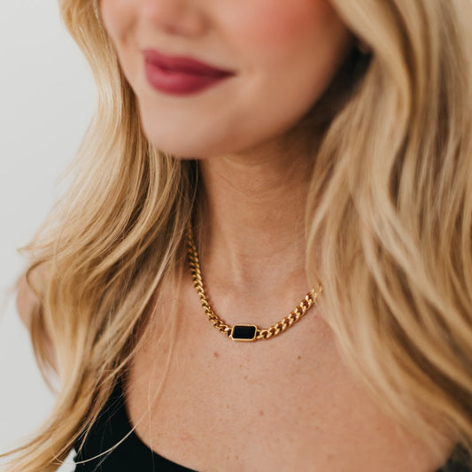 Gold chain necklace with black rectangular bezel pendant