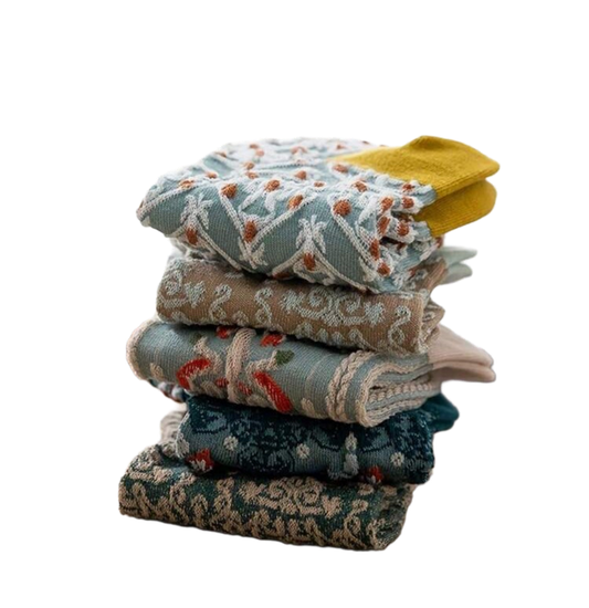 Stack of 5 women’s socks in teal, tan, light blue, and mustard with winter patterns