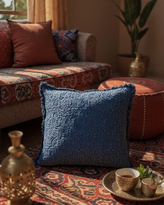 Blue indigo patterned throw pillow with medallion quilting and fringe border.