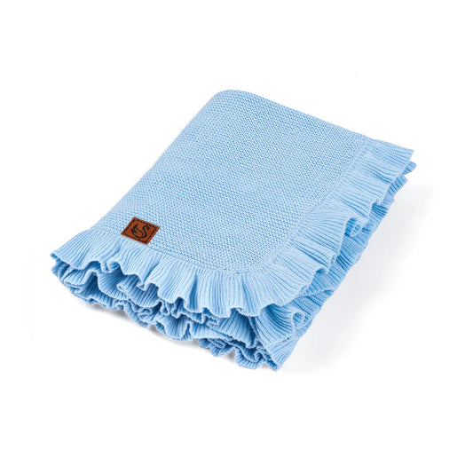 Folded baby blue knit baby blanket with ruffled edges and woven label patch