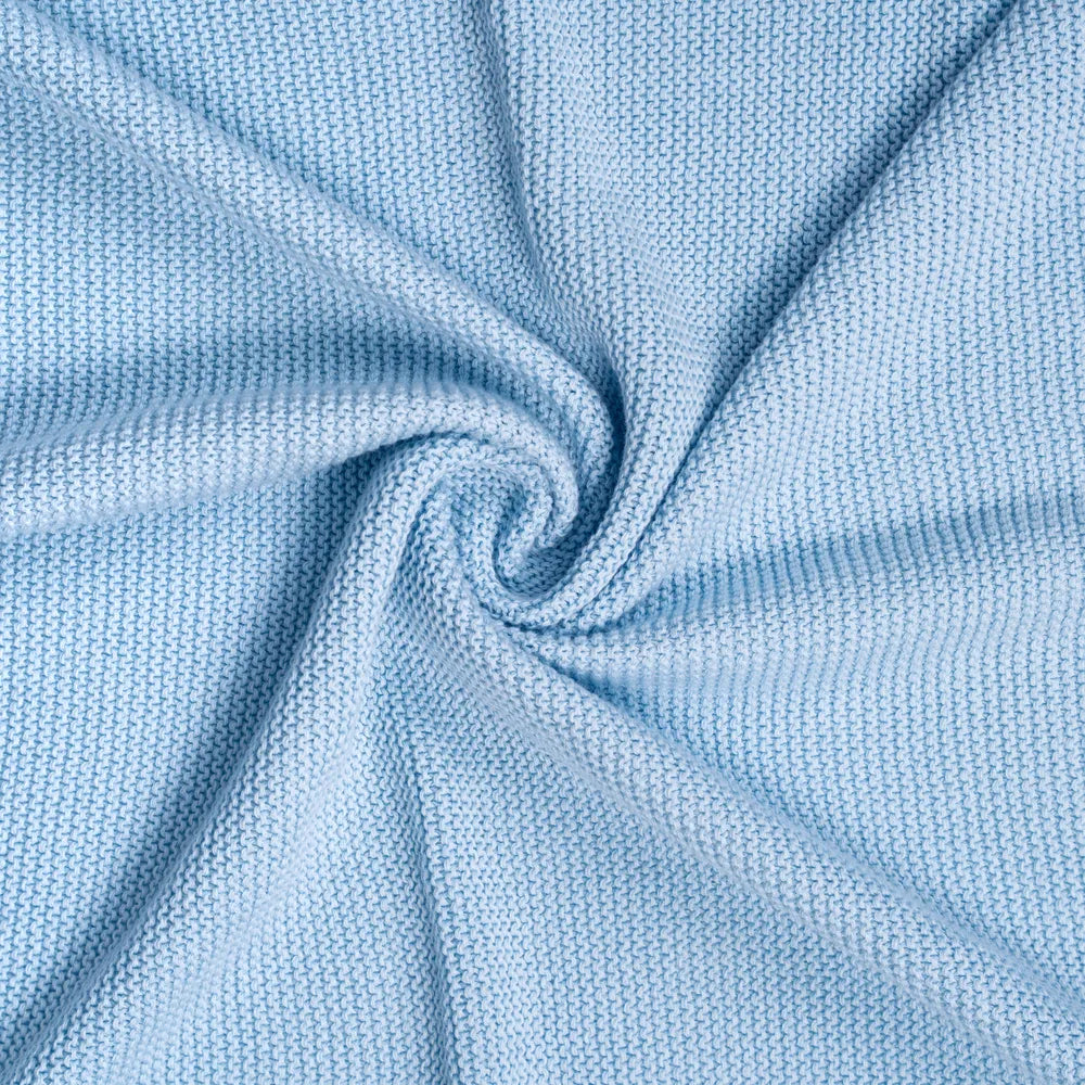 Close-up of baby blue knit fabric with soft, textured weave