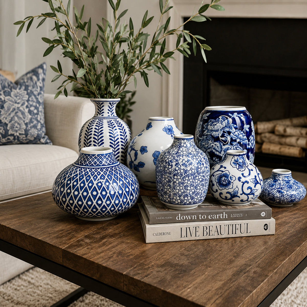 Blue and white patterned ceramic vases arranged on a wooden side table
