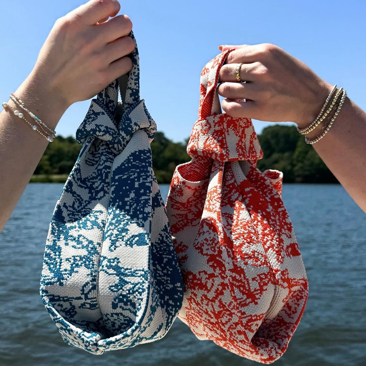 Handheld blue and white woven drawstring handbag pouch with knotted top