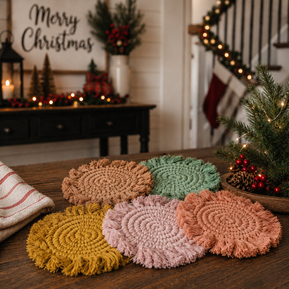 Braided rope tassel coasters arranged in mustard, tan, pink, and green on a tabletop