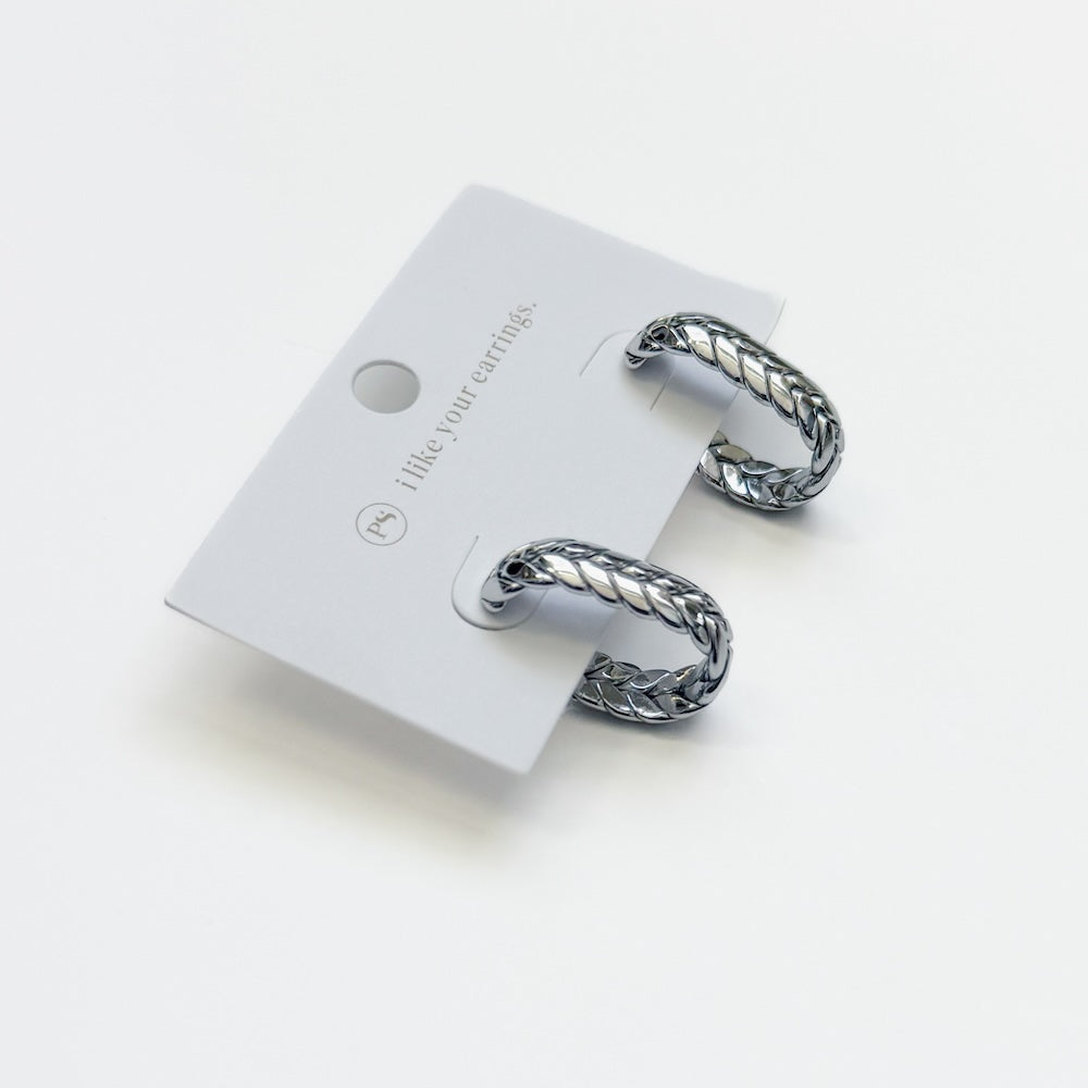 Silver braided oval hoop earrings pair with card backing.