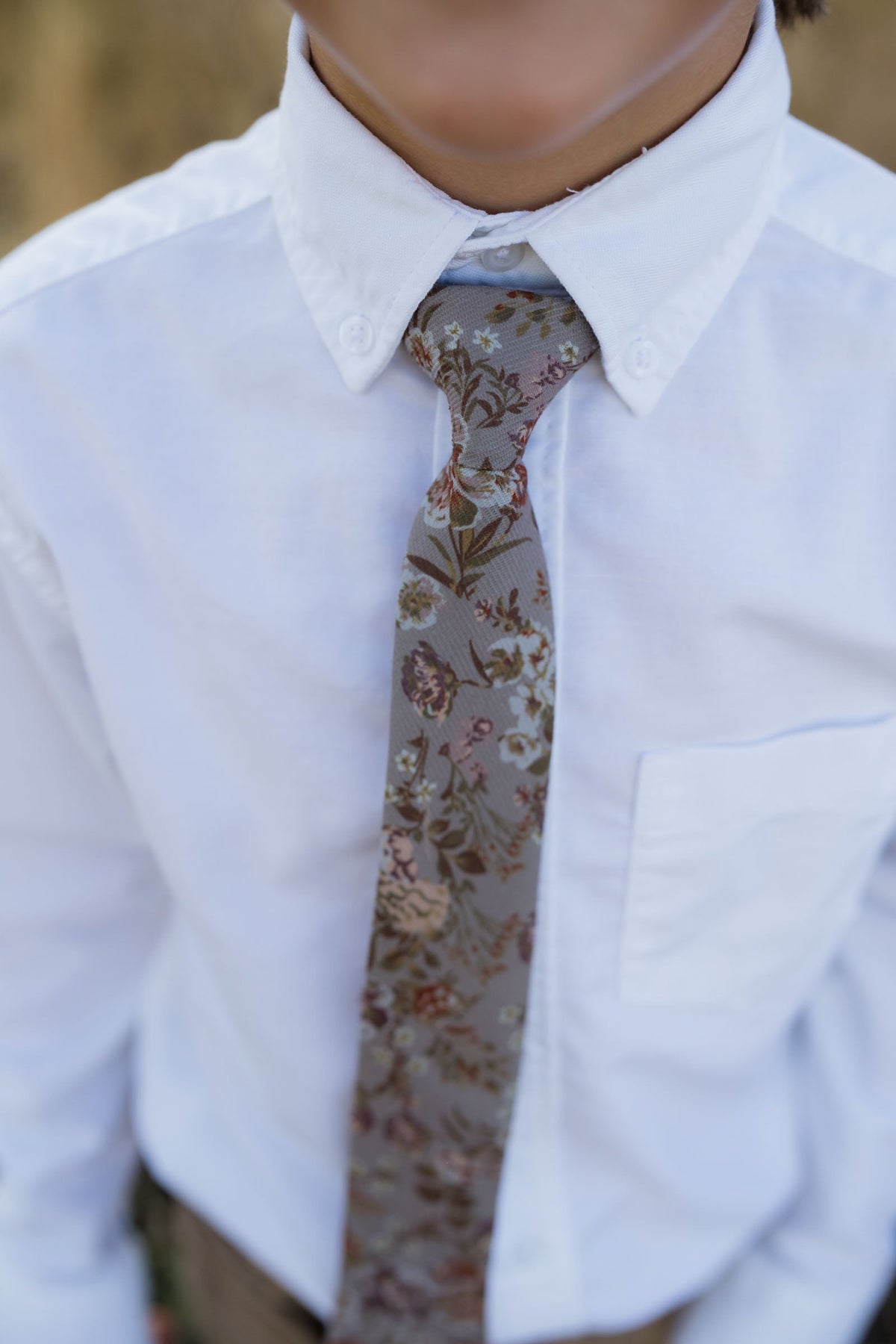 Boys tie close-up with tan and brown floral print