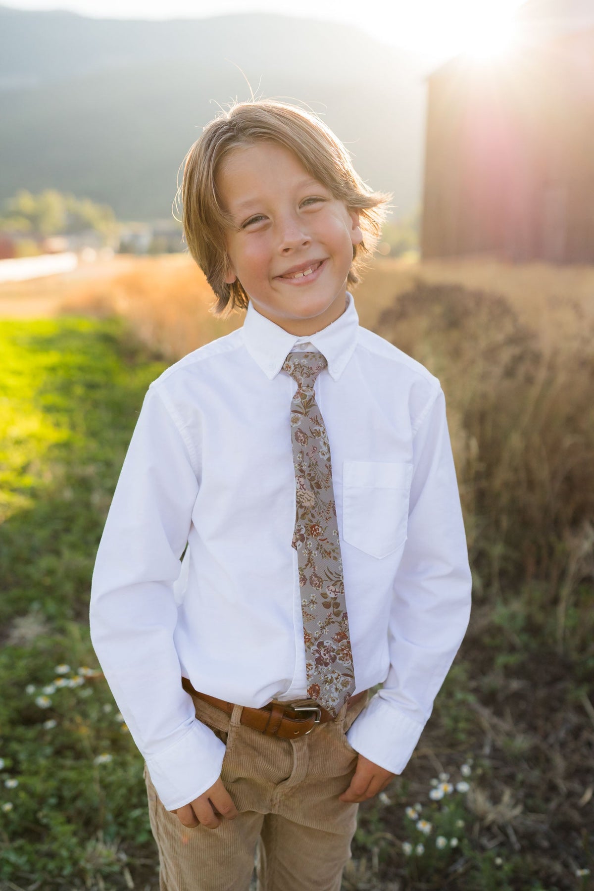 Briar Rose boys tie worn with white shirt; tan floral on brown