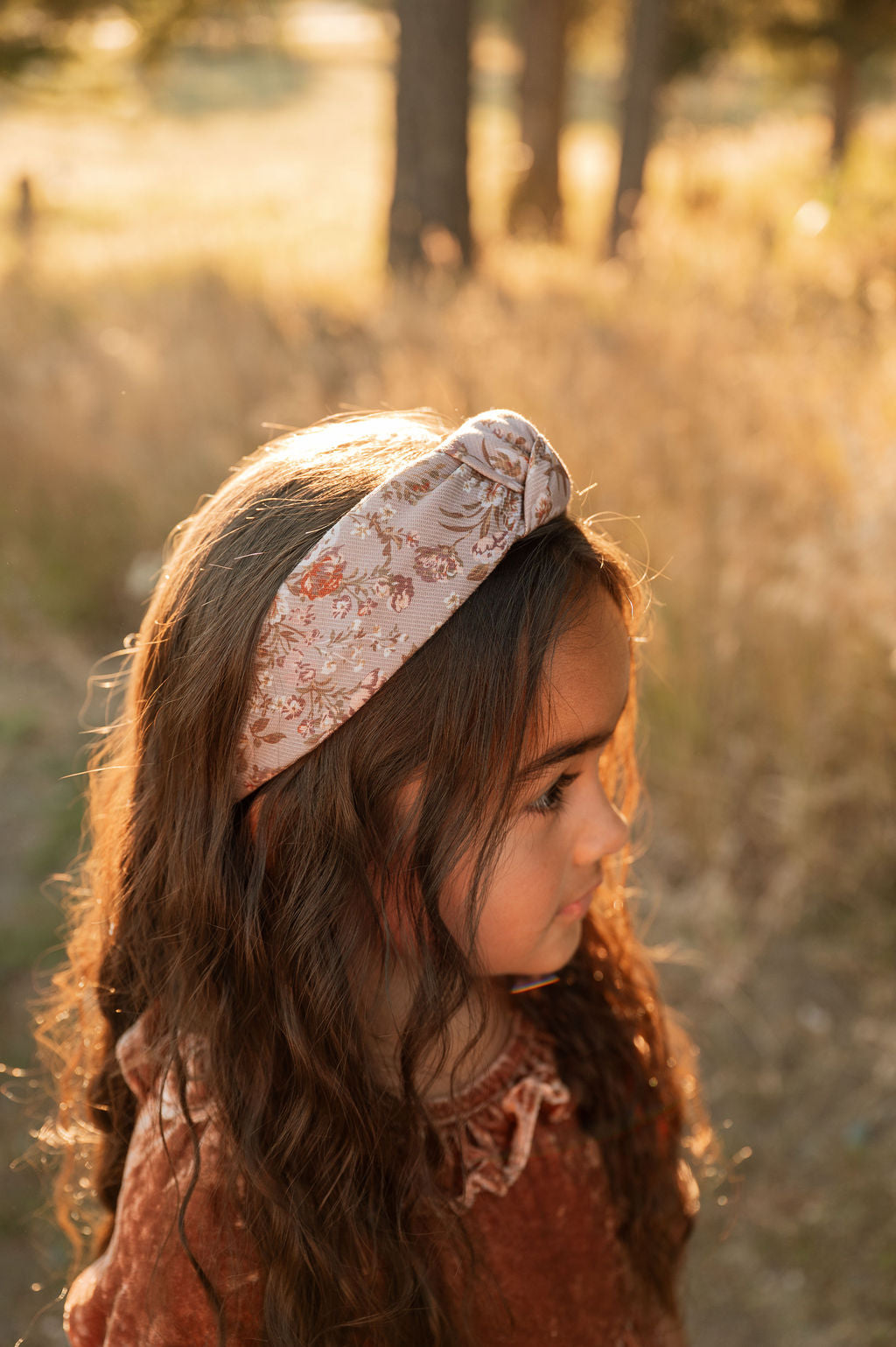 Floral knotted headband on child, beige with brown and rust flower print