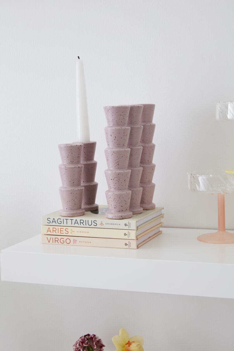 Speckled pink taper candleholder set with a tall candle and stacked cup holders