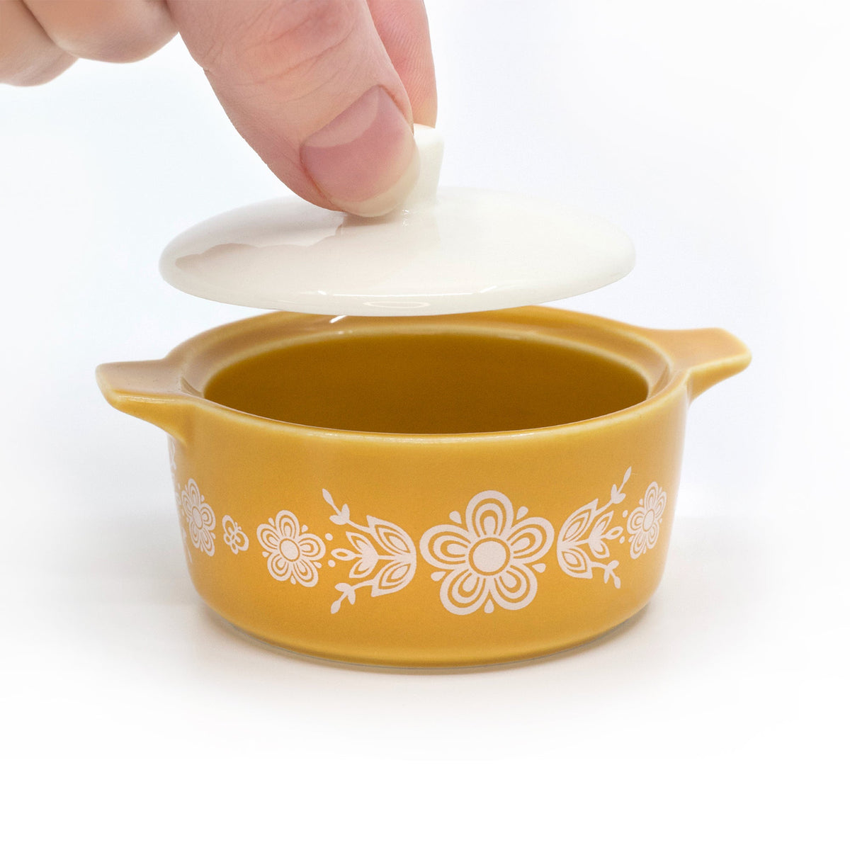 Yellow ceramic casserole trinket box with white lid lifted, floral butterfly pattern