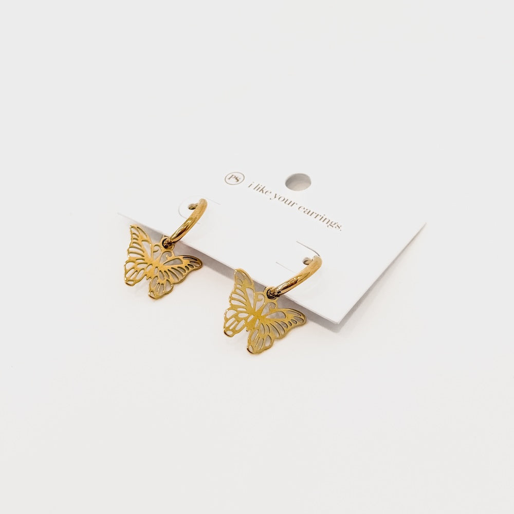 Pair of gold butterfly huggie drop earrings with butterfly charms
