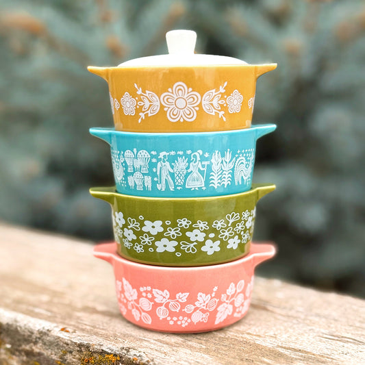 Stack of ceramic casserole trinket boxes with white, blue, and coral floral patterns