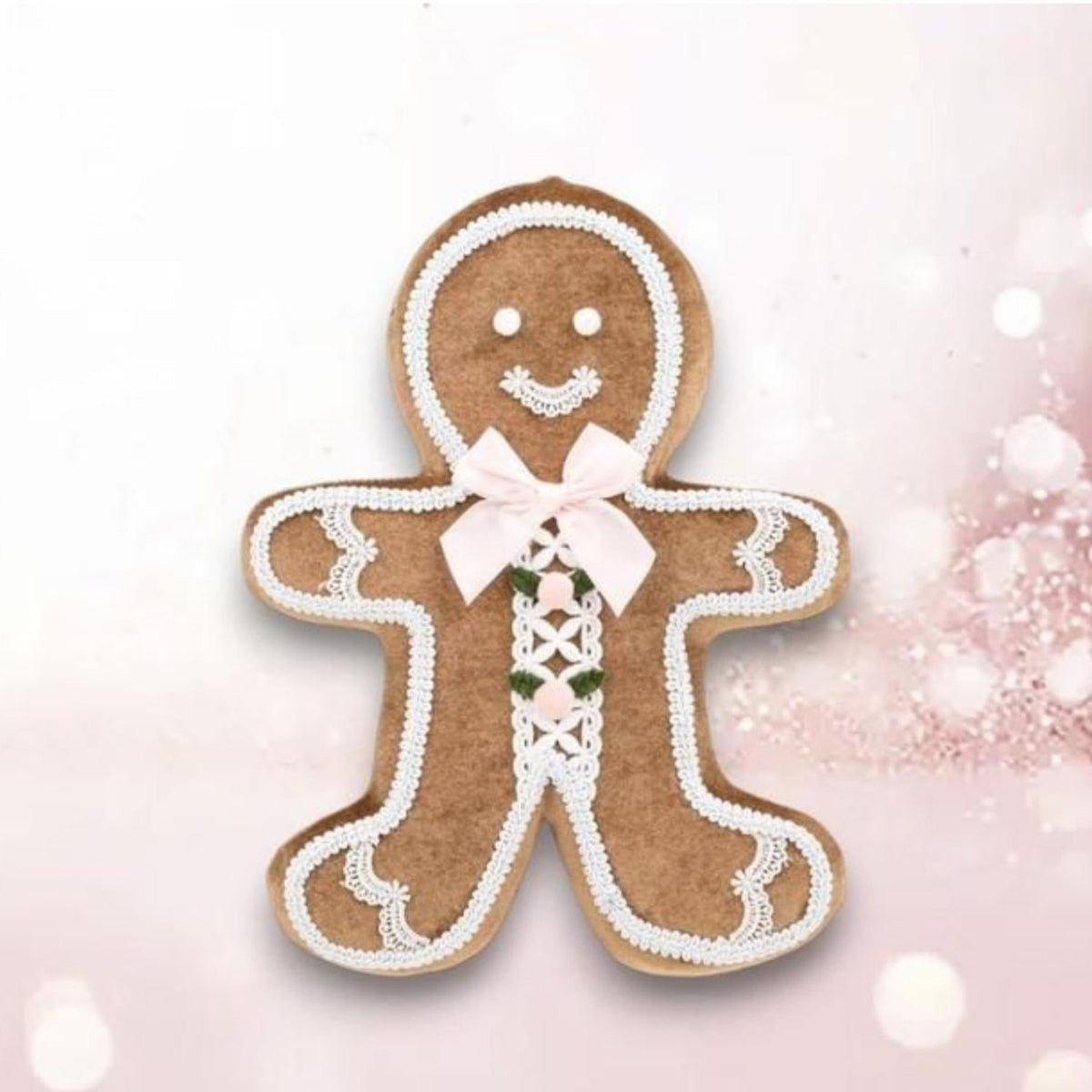 Gingerbread boy ornament, brown with white trim and pink bow; hanging loop top