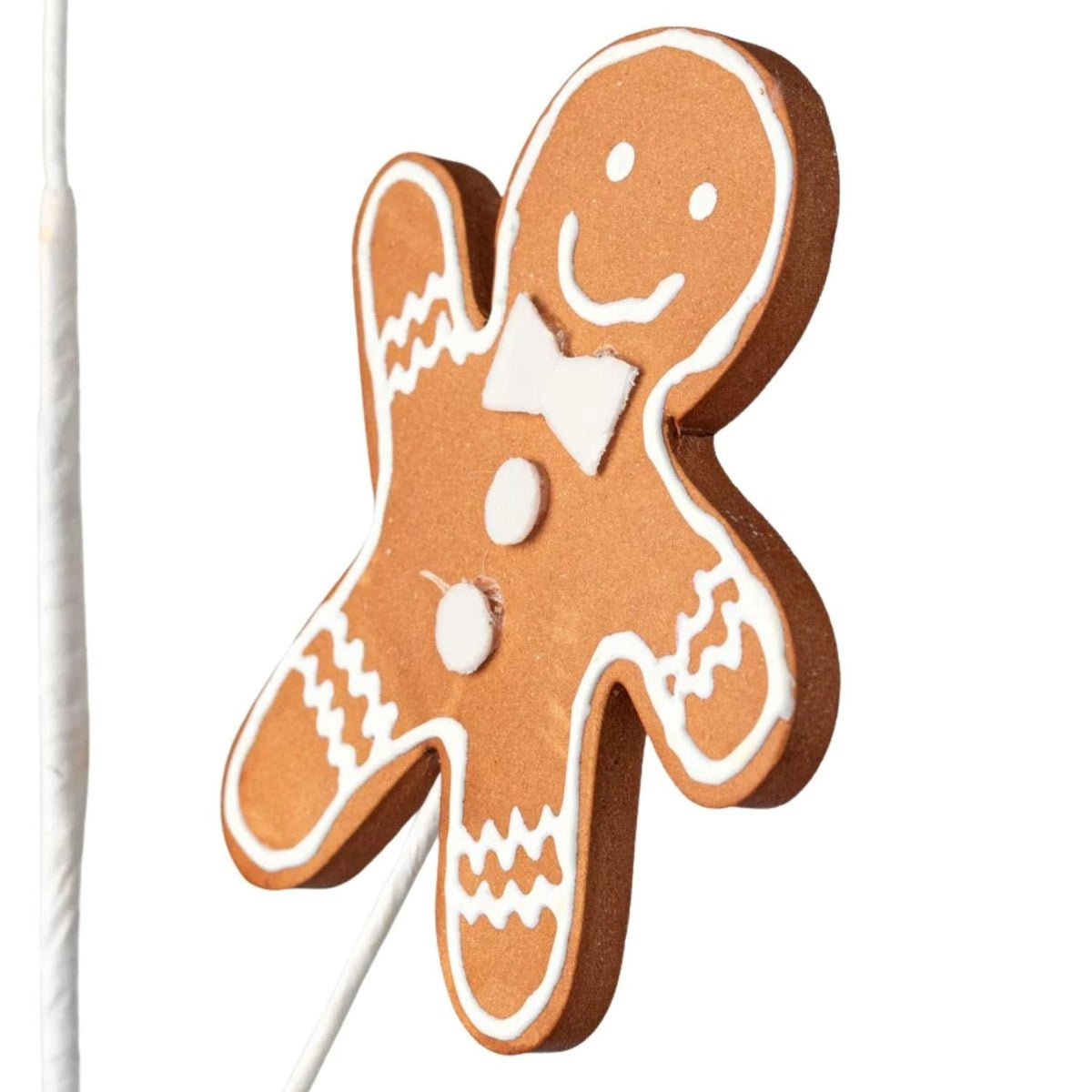 Gingerbread cookie figure topper with brown icing details and white outlines on a stem