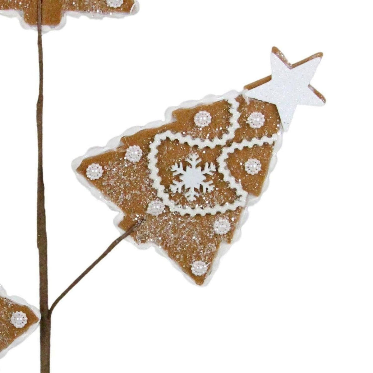 Close-up gingerbread tree ornament with white snowflake icing and glitter, on star-topped stem