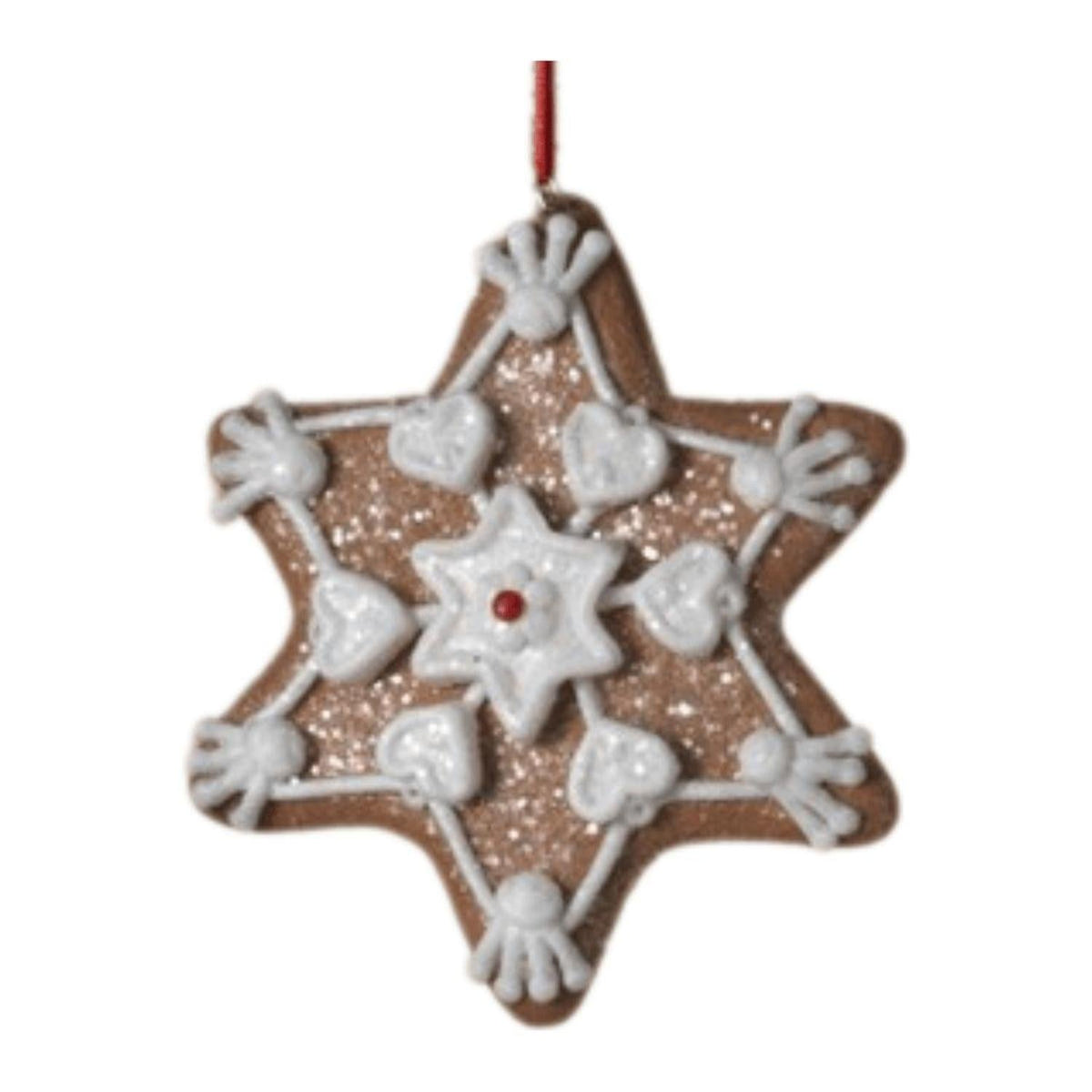 Star-shaped clay dough ornament with white icing outlines and a small red center dot