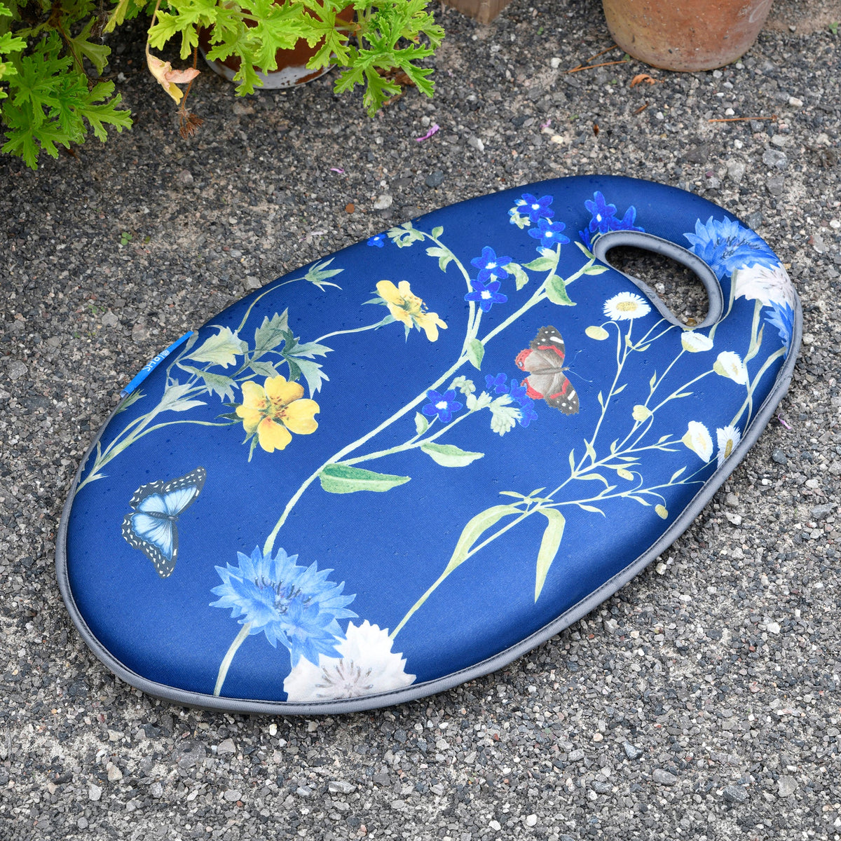 Blue floral gardening kneeler pad with handle, featuring butterflies and wildflowers
