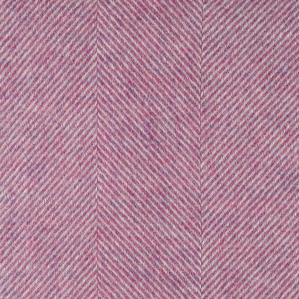 Close-up of petal pink herringbone weave texture on a throw blanket
