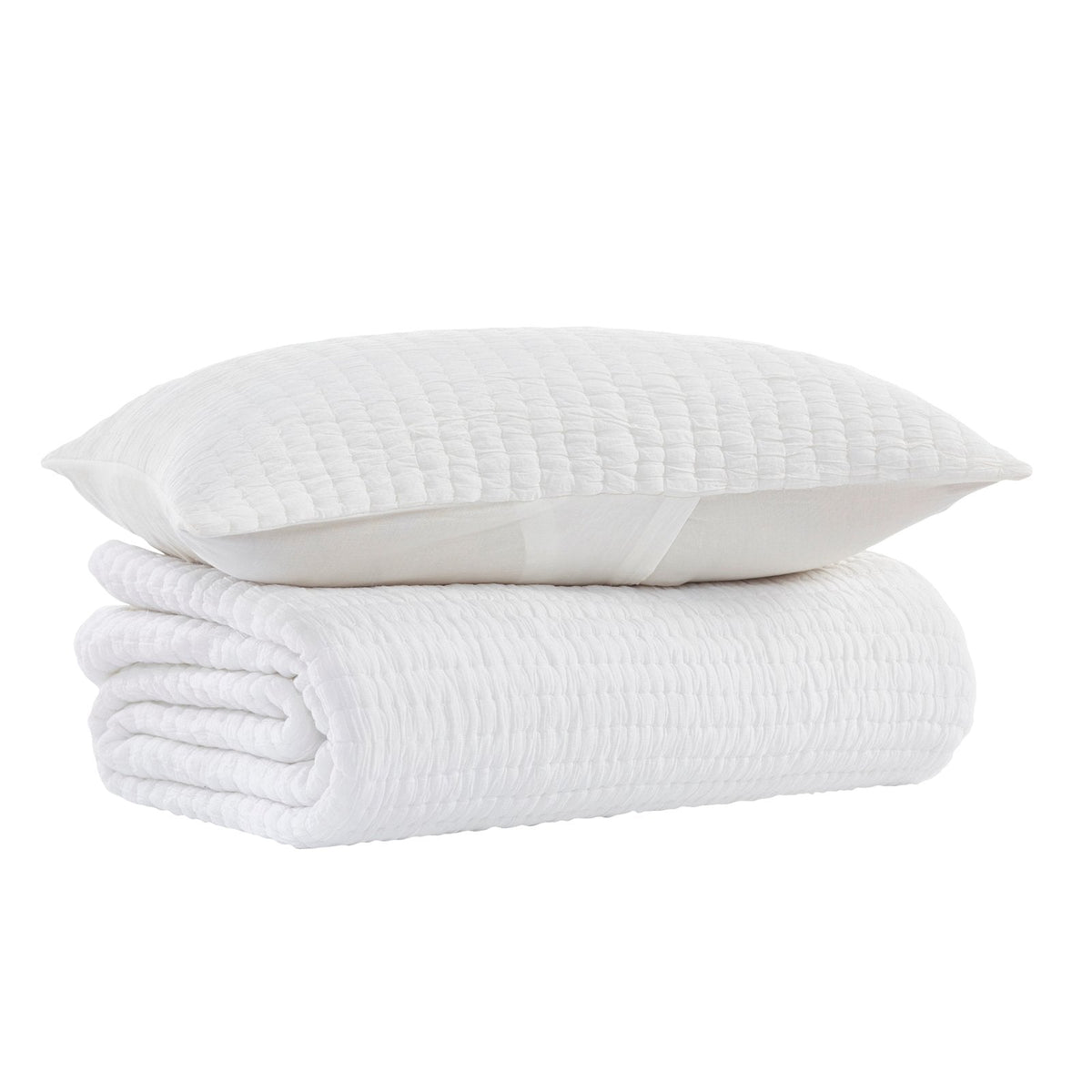 White cotton quilt stack with quilted crinkle texture and soft cushion pillow