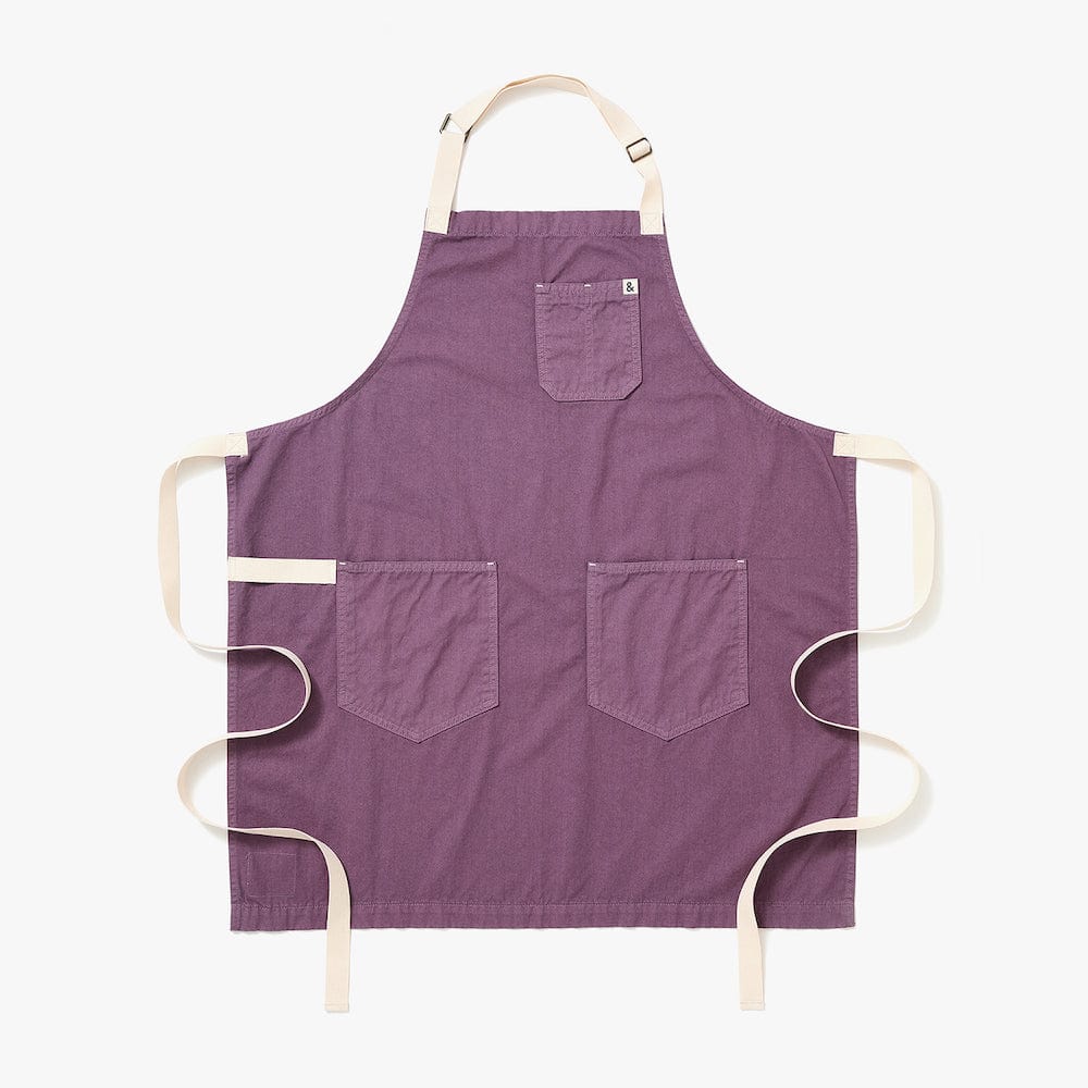 Lavender purple apron with two front pockets and cream neck and waist ties