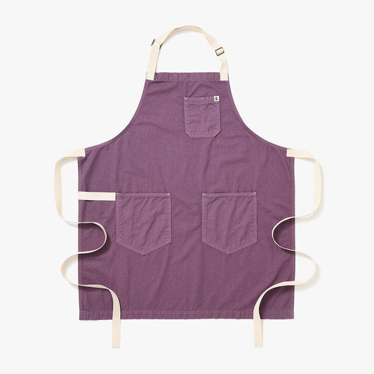 Lavender purple apron with two front pockets and cream neck and waist ties