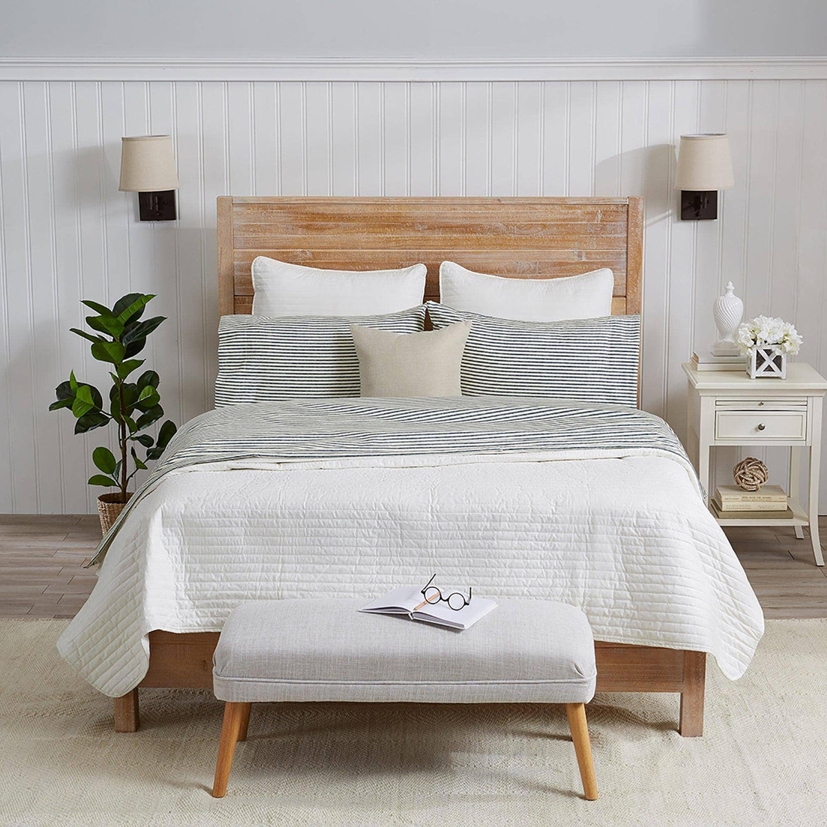 Blue striped microfiber sheet set on a bed with shams and top cover