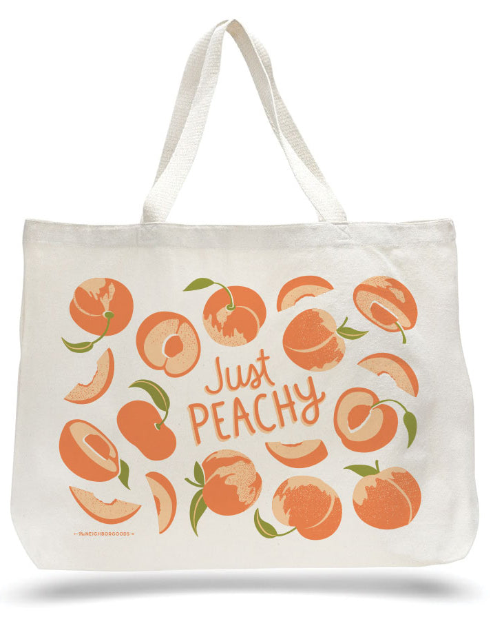 Peach canvas tote bag with green-and-orange fruit print and “Just Peachy” lettering
