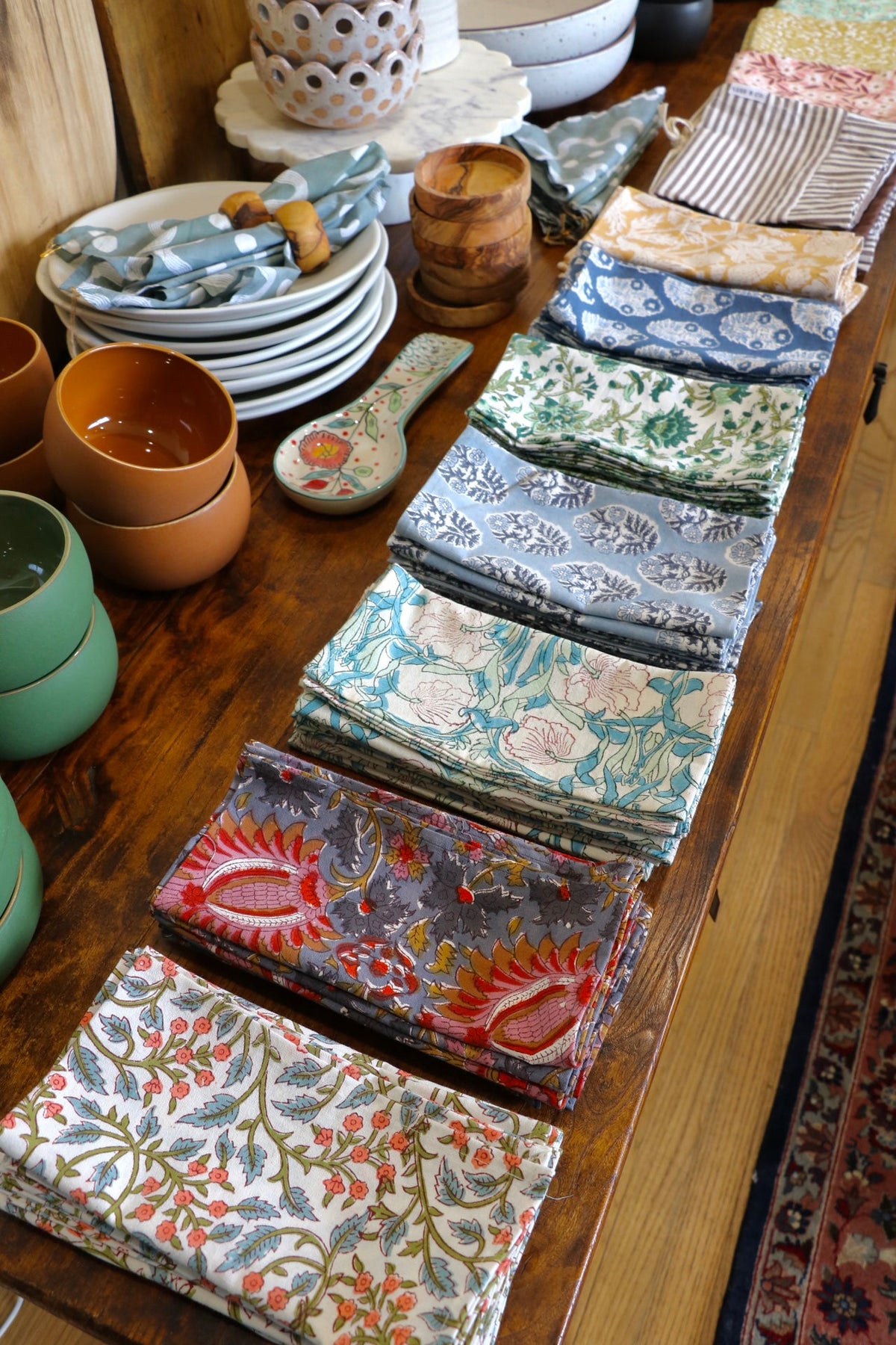 Botanical garden napkins assortment with mixed floral and stripe patterns, folded rectangles