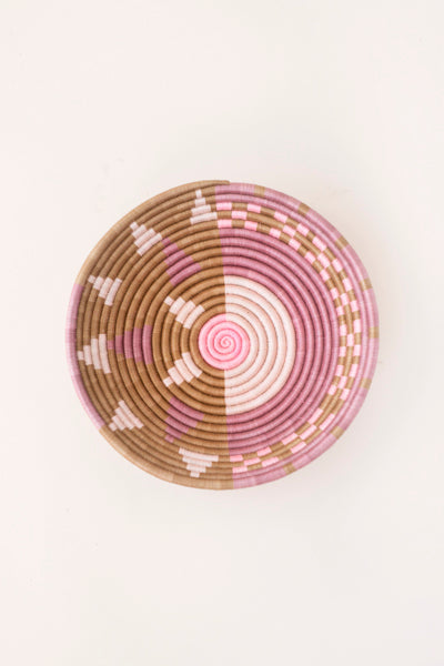 Purple and tan sunburst woven decorative plate with concentric spiral pattern