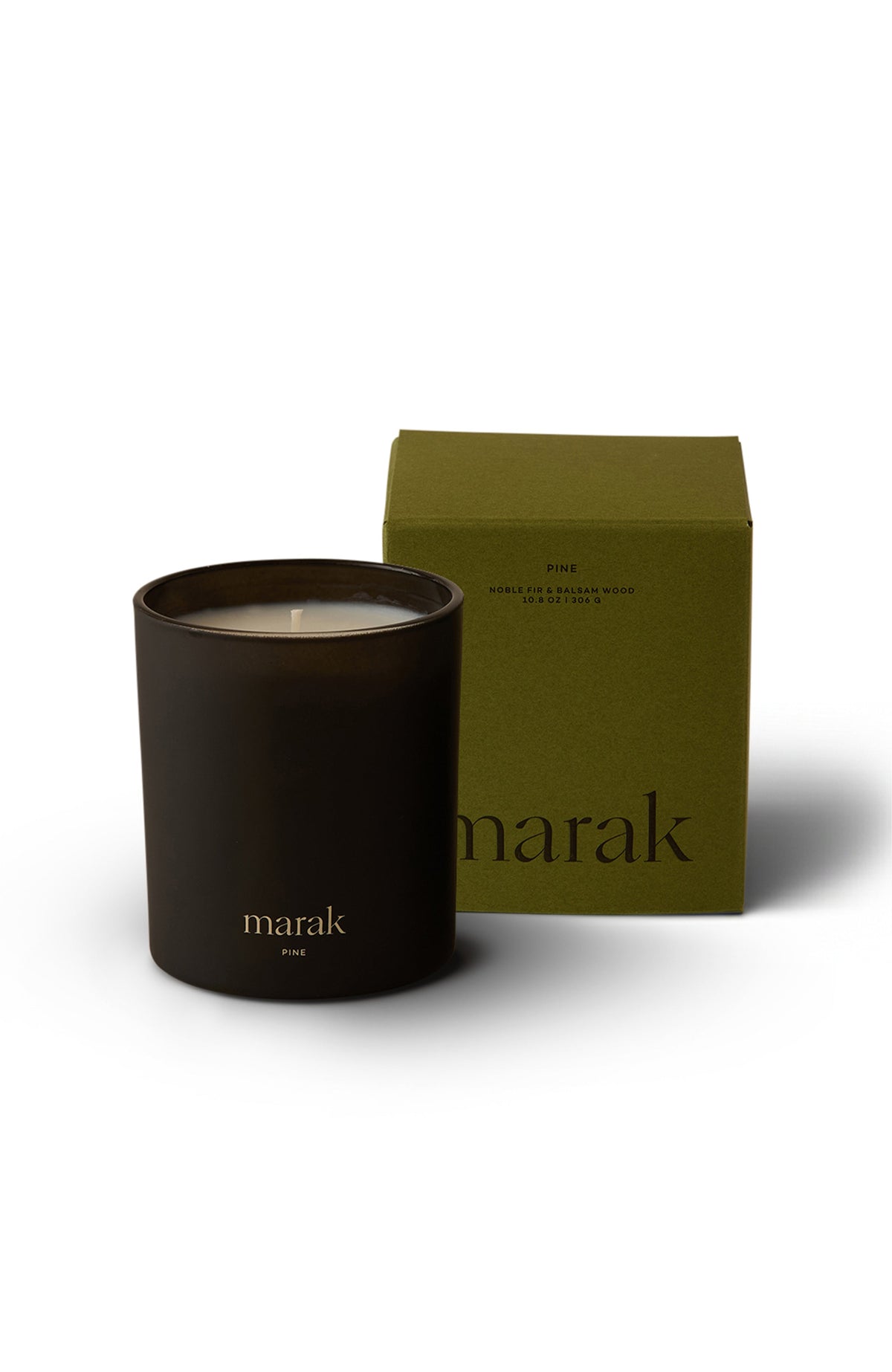 Small dark marak pine candle with green gift box behind