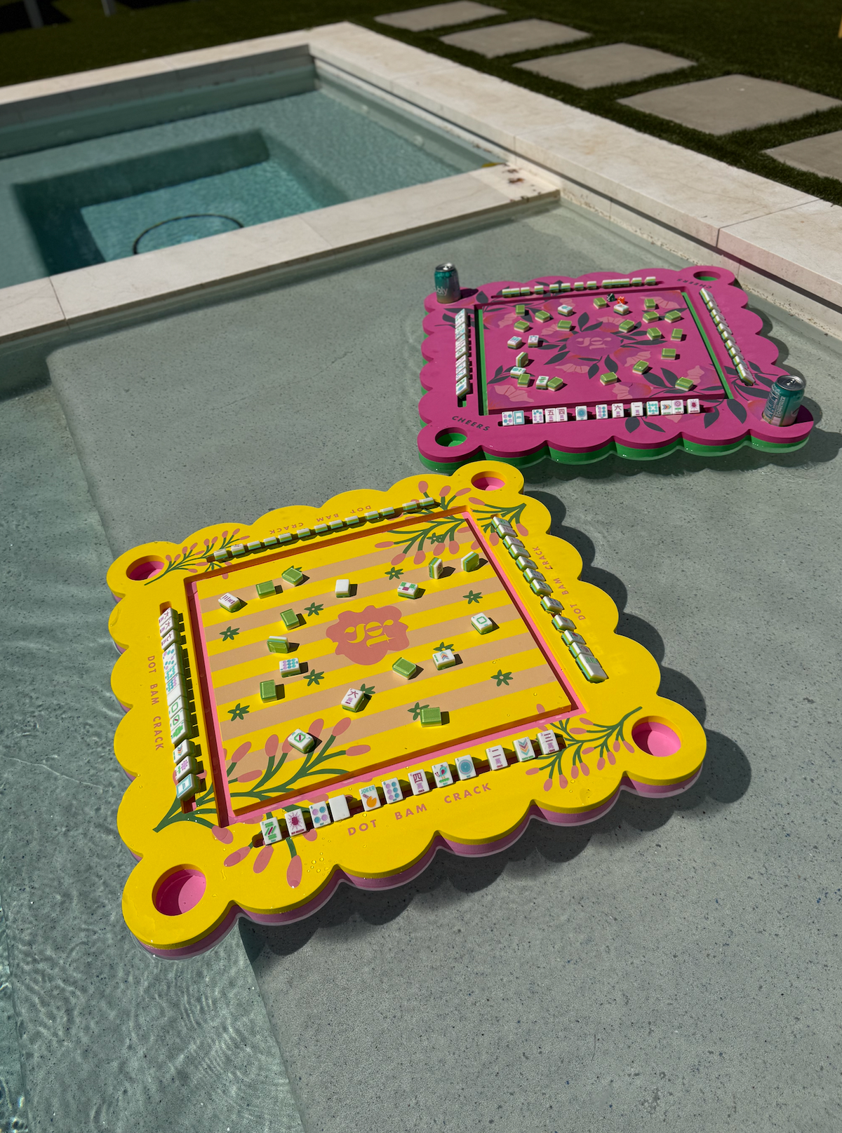 Neon floral pink floating mahjong tile mat on deck with floral border and corner pegs