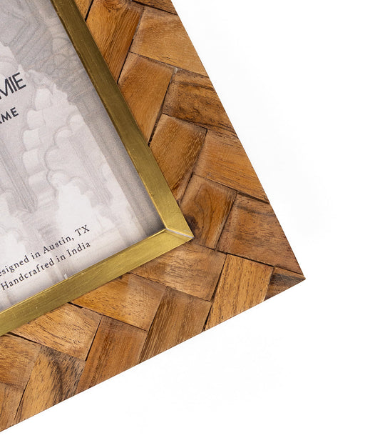 Angled view of carved wood 4x6 picture frame with brass inlay inner border.
