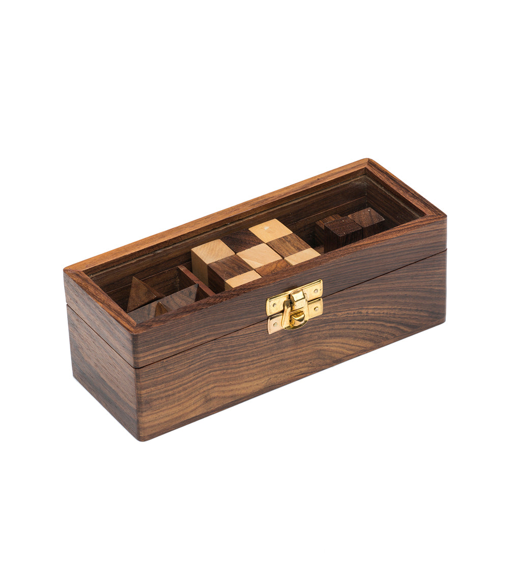 Wood geometric puzzle box with brass latch and carved dark slot compartments