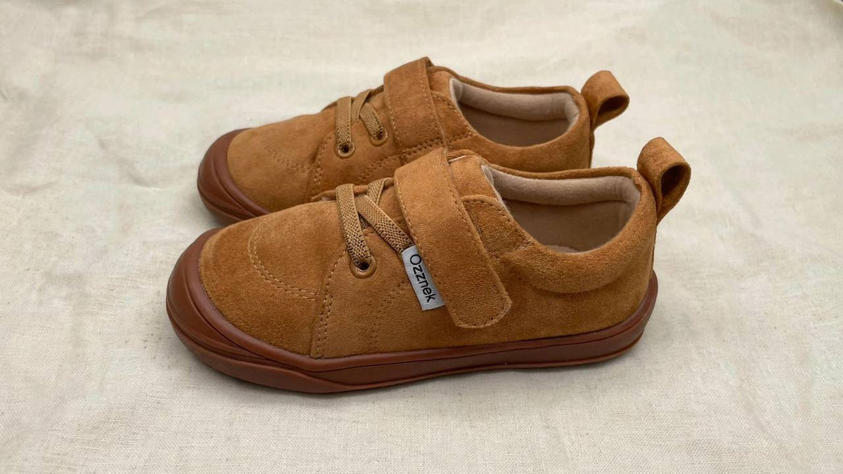 Kids' barefoot sneakers with tan upper, hook-and-loop strap, flexible gum sole