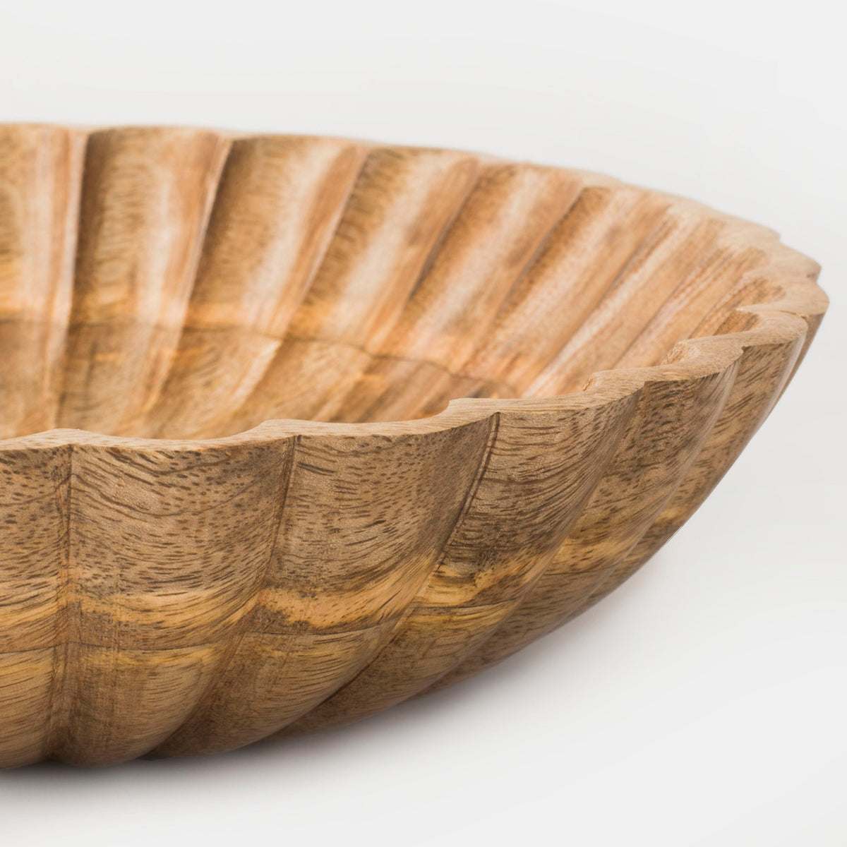 Close-up of natural scalloped wooden bowl interior with carved fluted texture