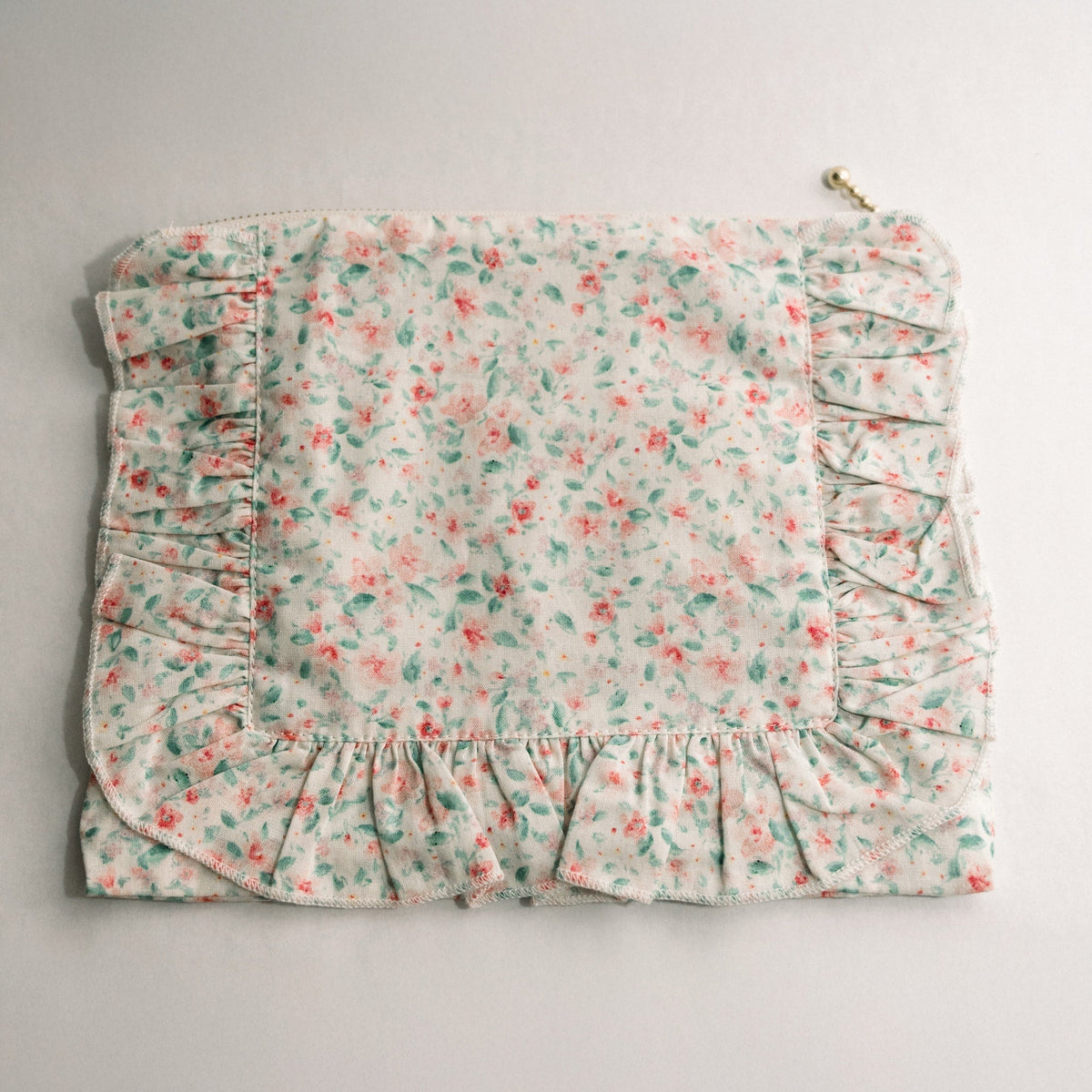Pastel floral ruffle zip pouch with gathered hem and pleated side panel