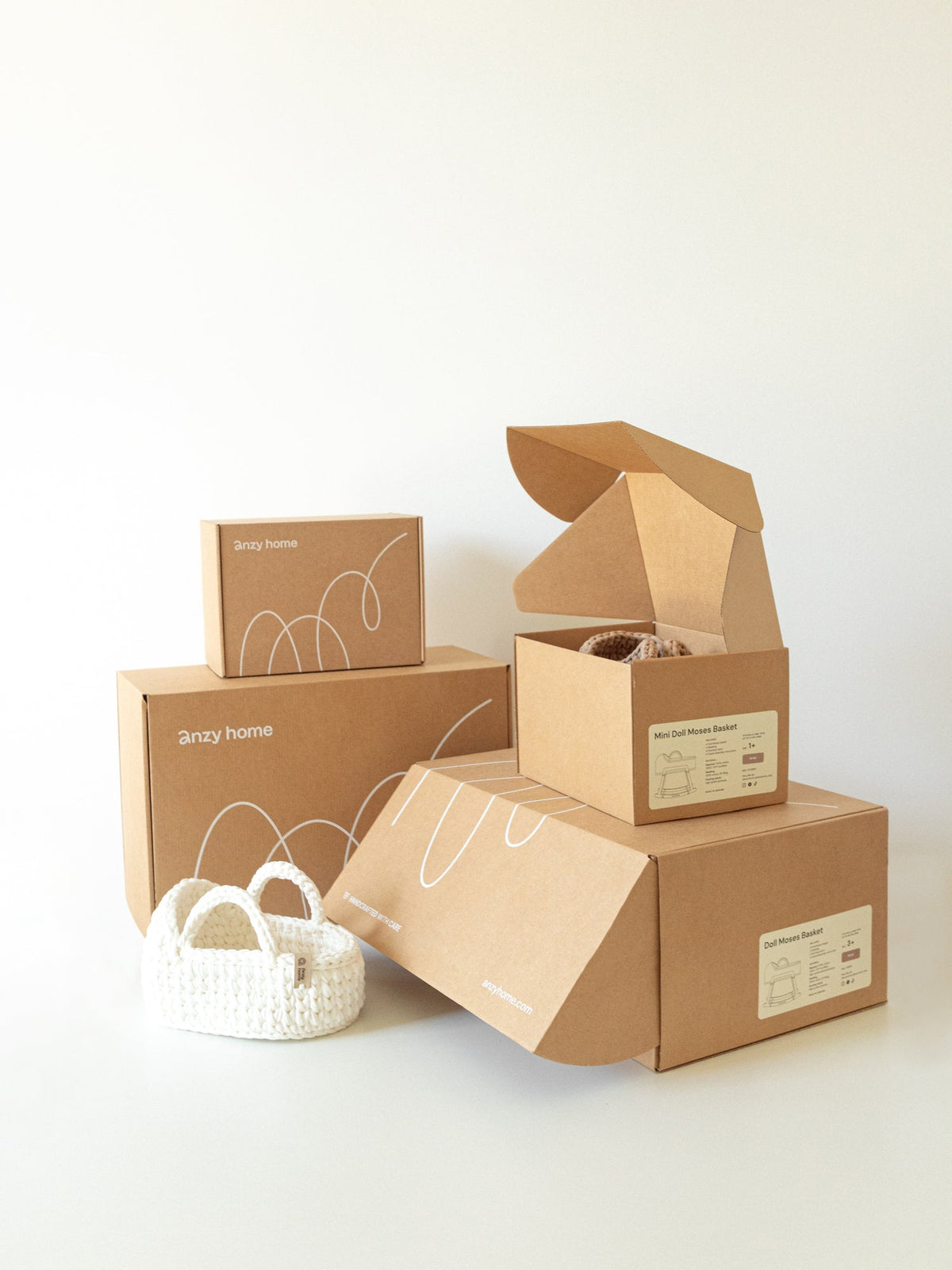 Mini doll moses basket with rocking stand set, shown in retail boxes